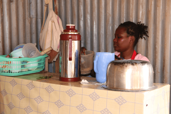 Evalyne Njeri preparing some food